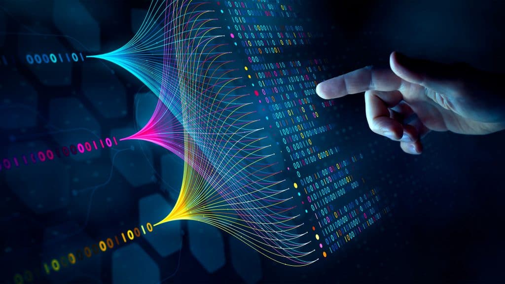 Mão quase tocando linhas coloridas de código em formato que ilustra conceito de inteligência artificial